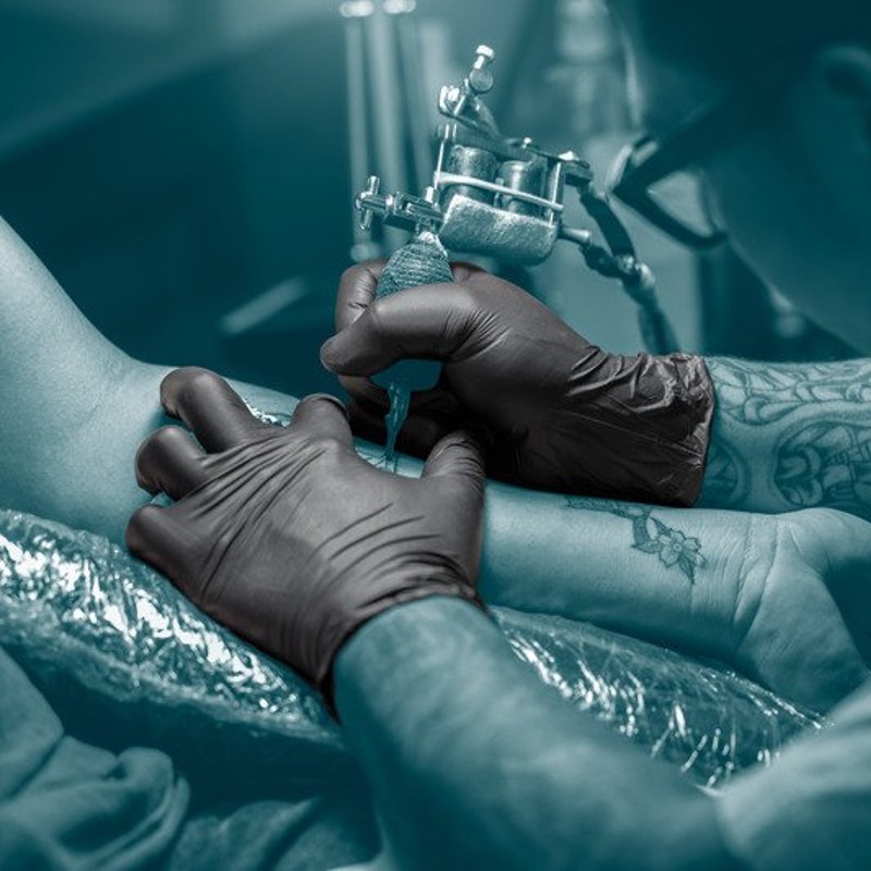 Why Do Tattoo Artists Wear Black Gloves? - Sunline Supply